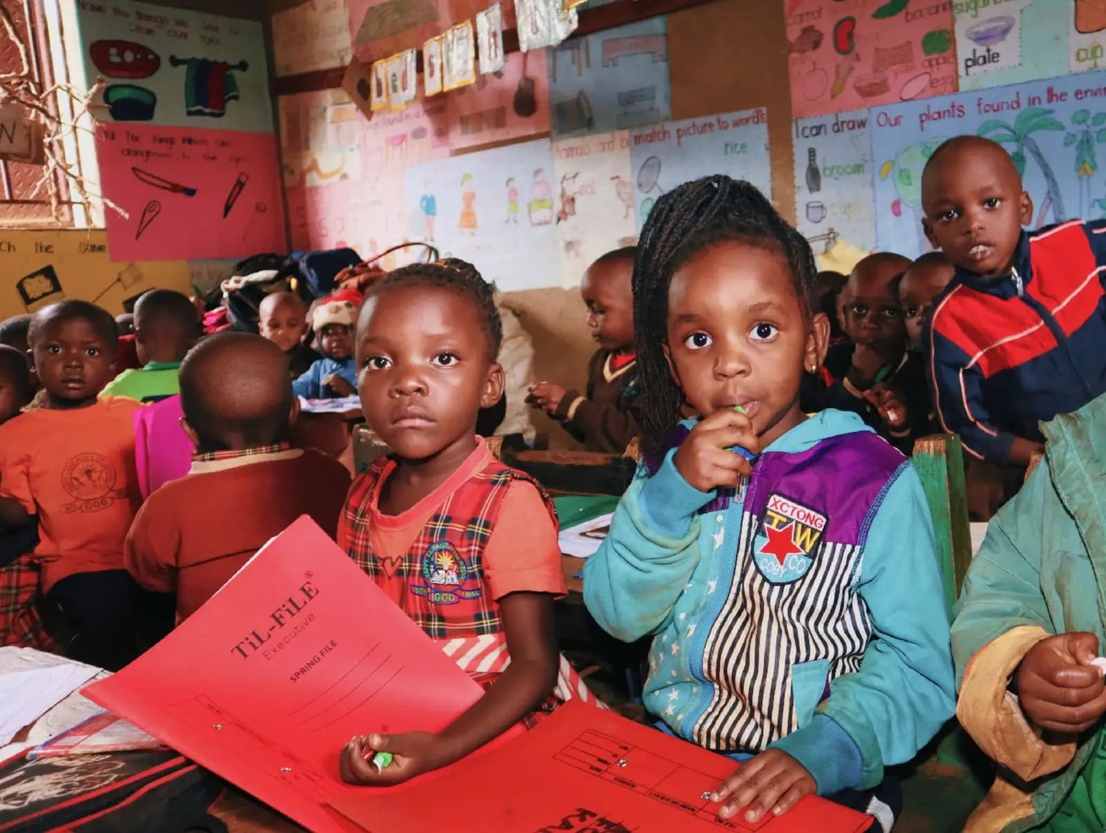 Young pupils in a bright, colourful classroom