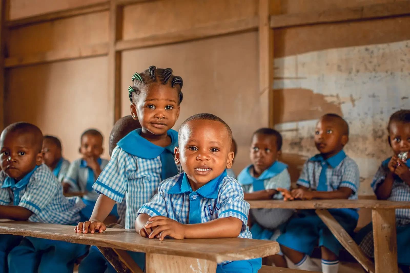 Nursery pupils in checked uniforms at their desks