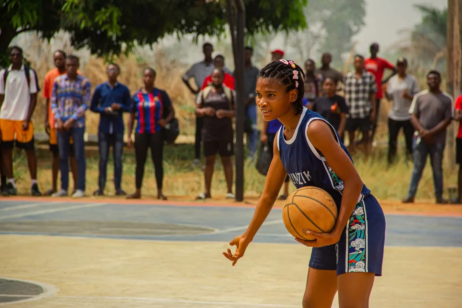 Girl dribbling a basketball on the school court
