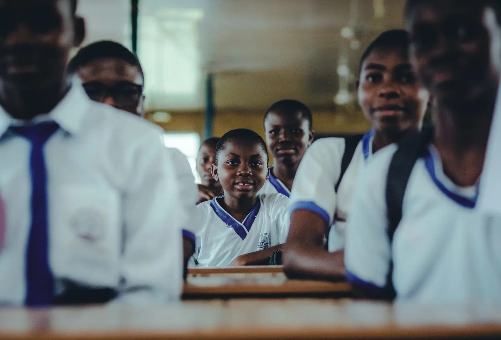 Secondary students in white shirts and ties in class